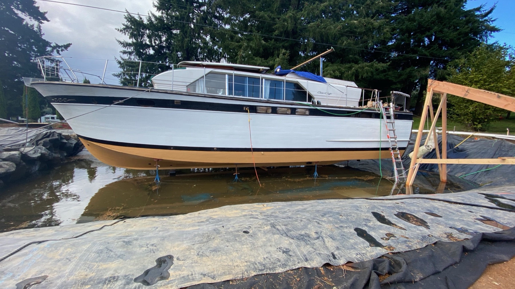 The 1963 Chris Craft supported above the unfinished pond liner